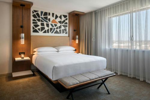 a bedroom with a large white bed and a window at Marriott Springfield Downtown in Springfield