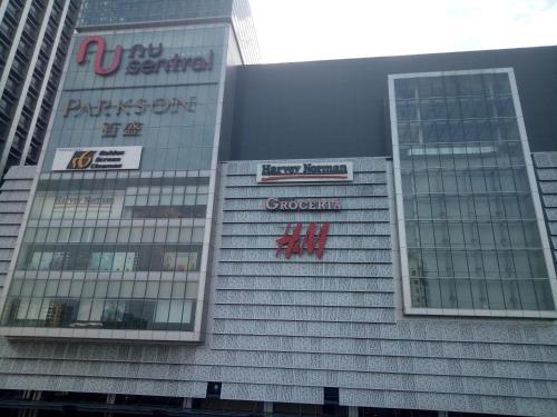 a tall building with signs on the side of it at Elite Hotel KL Sentral in Kuala Lumpur