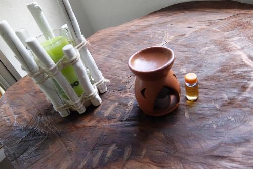 a wooden table with a cup and a drink on it at Vi Miles Lodge in Mahe