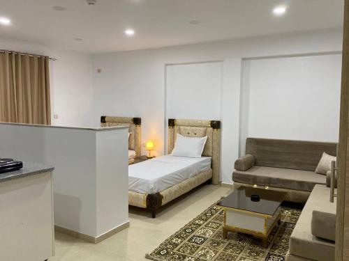 a living room with a bed and a couch at Résidence Elkhir Djerba in Djerba
