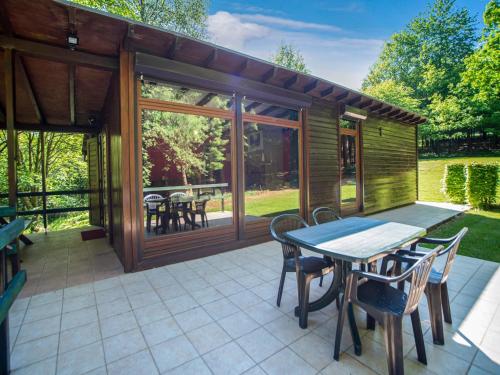 a patio with a table and chairs on a patio at Seneric Chalet, Trois-Ponts in Trois-Ponts