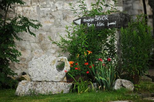 a garden with a teddy bear sitting next to a sign at Holiday Farmhouse Skvor in Robidišče