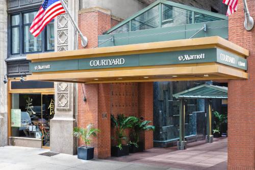 an outside view of a restaurant with an american flag at Courtyard New York Manhattan/Times Square in New York