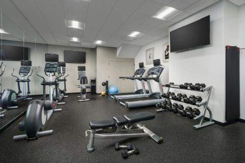 a gym with several machines and a flat screen tv at Courtyard New York Manhattan/Times Square in New York