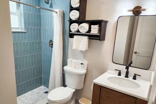 a bathroom with a toilet and a shower and a sink at Marco Island Lakeside Inn in Marco Island