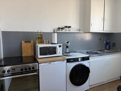 a kitchen with a microwave and a stove at Studio cosy en hypercentre de Louviers in Louviers