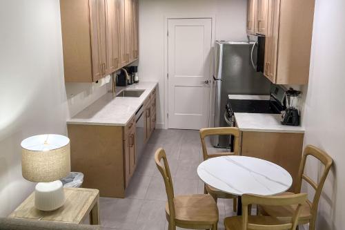 a kitchen with a table and chairs and a refrigerator at Marco Island Lakeside Inn in Marco Island
