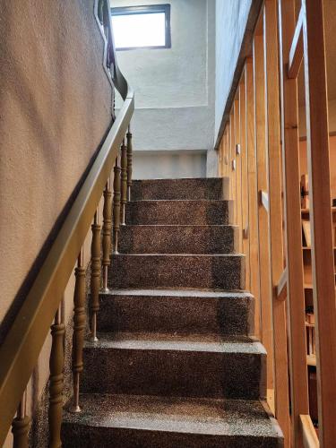 a stairway in a building with a window at In68 House in Ch'ih-k'an-lou
