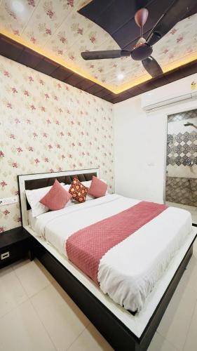 a bedroom with a large bed with a ceiling at Nahargarh view Hotel in Jaipur