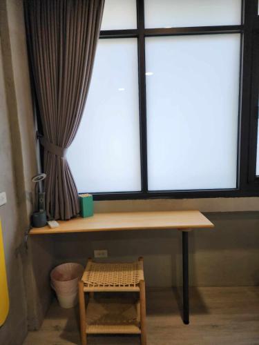 a window with a table and a stool in front of it at In68 House in Ch'ih-k'an-lou