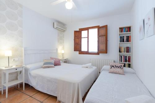 a bedroom with two beds and a book shelf at Villa Aurea in La Alcayna