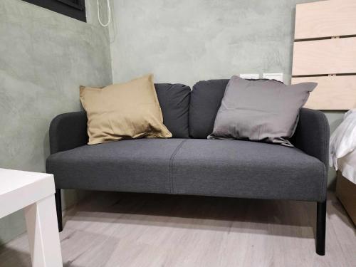 a couch with two pillows on it in a room at In68 House in Ch'ih-k'an-lou
