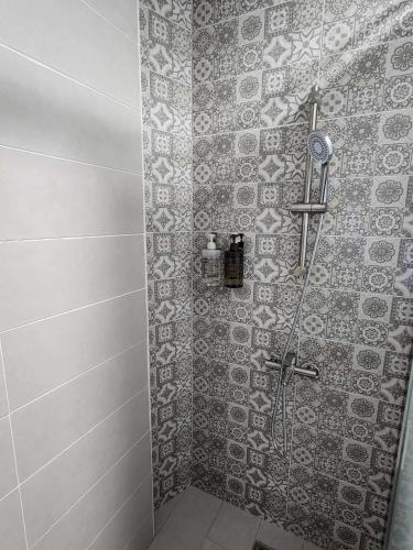 a bathroom with a shower with a tile wall at In68 House in Ch'ih-k'an-lou