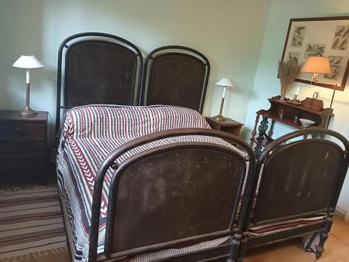 an old bed with a blanket on it in a room at Wonderfull counrty villa, views on sea & Capalbio in Pescia Fiorentina