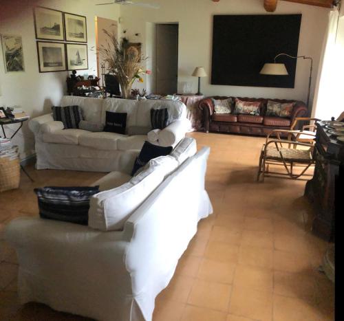 a living room with two white couches and a table at Wonderfull counrty villa, views on sea & Capalbio in Pescia Fiorentina