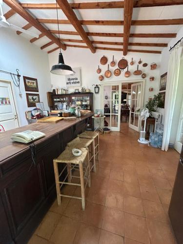 a large kitchen with a large counter and wooden ceilings at Wonderfull counrty villa, views on sea & Capalbio in Pescia Fiorentina