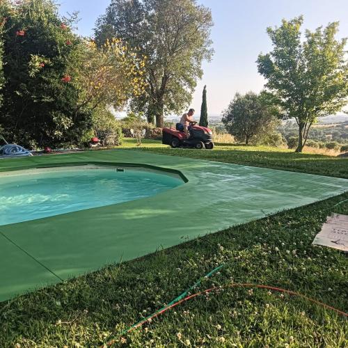 a man on a tractor fertilizing a golf course at Wonderfull counrty villa, views on sea & Capalbio in Pescia Fiorentina