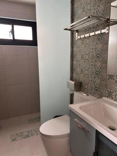 a bathroom with a toilet and a sink at In68 House in Ch'ih-k'an-lou