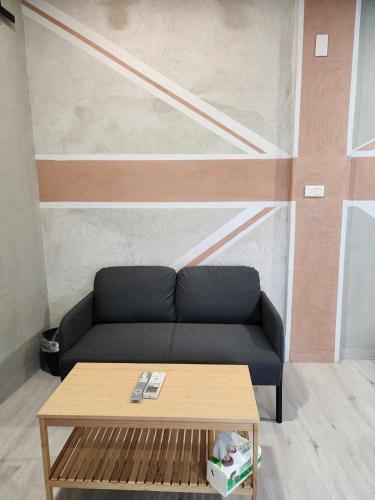 a living room with a couch and a coffee table at In68 House in Ch'ih-k'an-lou