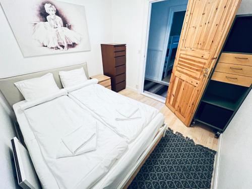 a small bedroom with a bed and a wooden cabinet at VasaLodge Sälen in Sälen