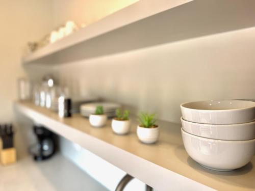 a shelf with bowls and potted plants on it at Royalty Maples Motel & Cottages in Charlottetown
