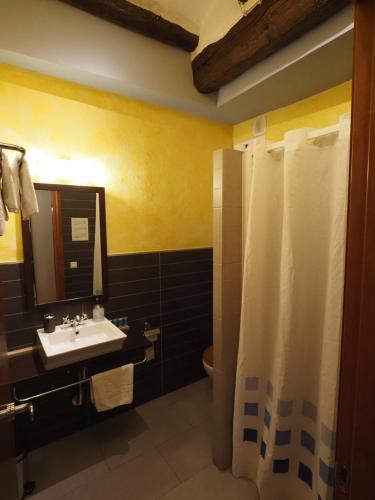 a bathroom with a sink and a toilet and a mirror at Apartaments El Jaç in Montblanc