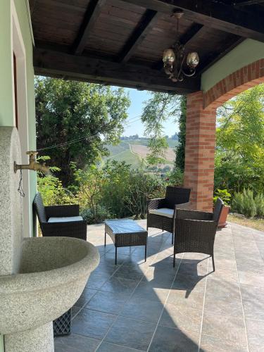 a patio with a stone fountain and chairs and a table at I Pesci De Boschi in Borgo Priolo