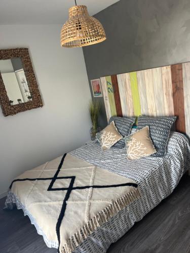 a bedroom with a bed and a mirror at La Villa Préfaillaise in Préfailles