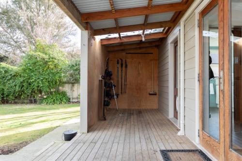 a porch with a wooden door on a house at 2 Storey Villa, Games room, Ski storage in Methven