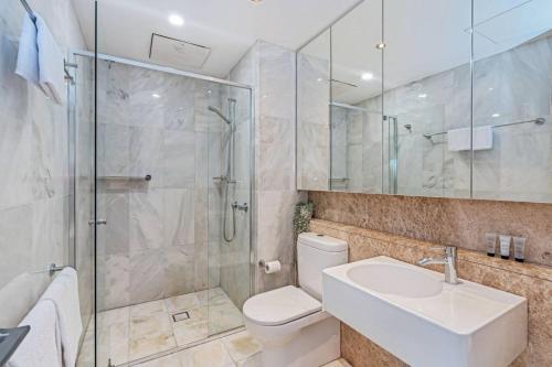 a bathroom with a shower and a toilet and a sink at Glebe Park Cityside with Style in Canberra