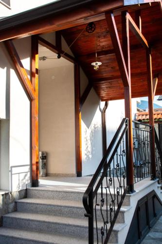 a stairway leading to a building with a wooden roof at Орбелус in Bansko