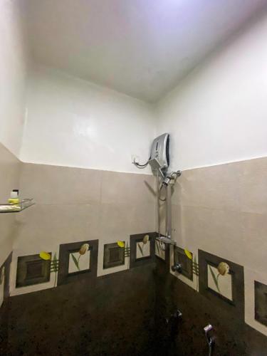 a bathroom with a urinal with a row of mirrors at Sky Garden Kandy in Kandy