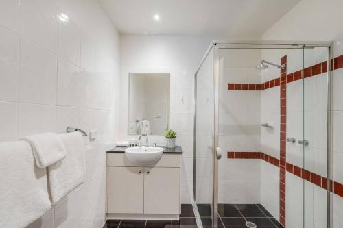 ein weißes Badezimmer mit Waschbecken und Dusche in der Unterkunft Spacious 2 Brm City-side in Turner