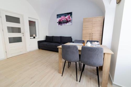 a living room with a table and chairs and a couch at Storczyk in Duszniki Zdrój