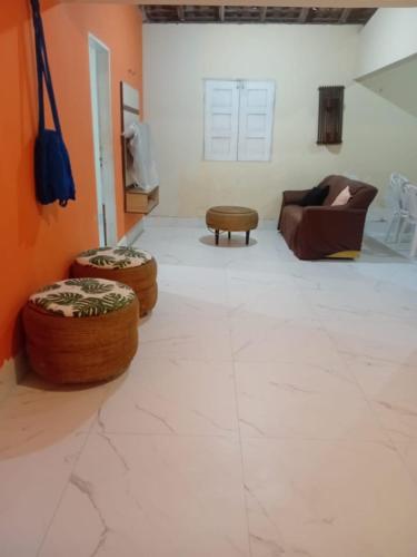 a living room with a couch and two ottoman at Casa Santos in Santo Amaro