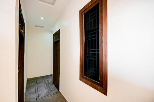 a room with a door and a window on a wall at Super Hotel O Brij Inn and Banquets in Lucknow