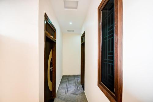 a hallway with a door and a tile floor at Super Hotel O Brij Inn and Banquets in Lucknow