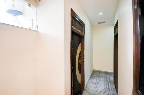 a hallway with a wooden door in a room at Super Hotel O Brij Inn and Banquets in Lucknow