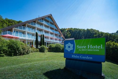 a hotel sign in front of a building at Sure Hotel by Best Western Rhoen Garden in Poppenhausen