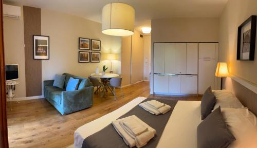a living room with a bed and a couch and a table at Residence Poggio Golf Chianti Firenze in Impruneta
