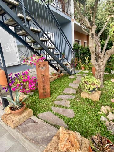 a garden with flowers and a walkway in front of a building at RavennaMia in Ravenna