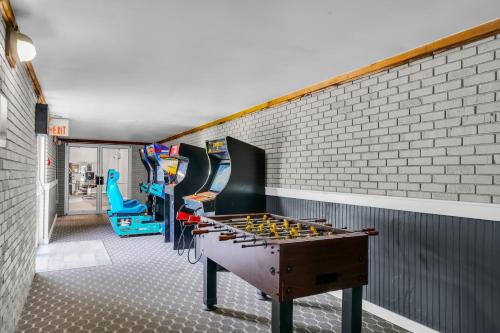 a play room with a foosball table and chairs at Hotel O Suites & Conference Centre Urbana-Champaign University in Urbana