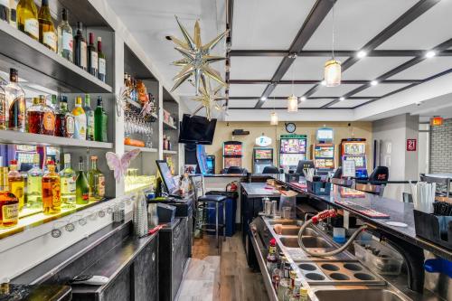 a bar with lots of drinks and alcohol at Hotel O Suites & Conference Centre Urbana-Champaign University in Urbana