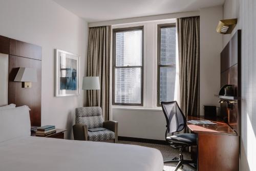 a hotel room with a bed and a desk and a chair at River Hotel in Chicago