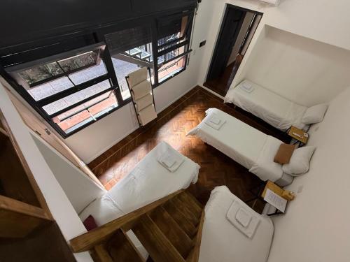 an overhead view of a living room with white furniture at Clivias Hostel in Salta