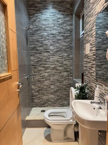 a bathroom with a toilet and a sink and a shower at Apartment Heart of Medina Tetuan in Tetouan