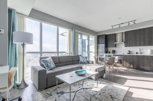 a living room with a couch and a table at 1 Bedroom 26 Floor DT near CN Tower in Toronto