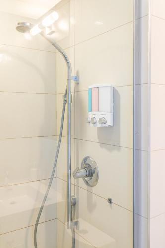 a shower with a shower head in a bathroom at 1 Bedroom 26 Floor DT near CN Tower in Toronto