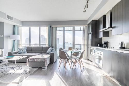 a living room with a couch and a table at 1 Bedroom 26 Floor DT near CN Tower in Toronto