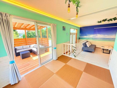 a living room with a view of the ocean at mini villa in Nago